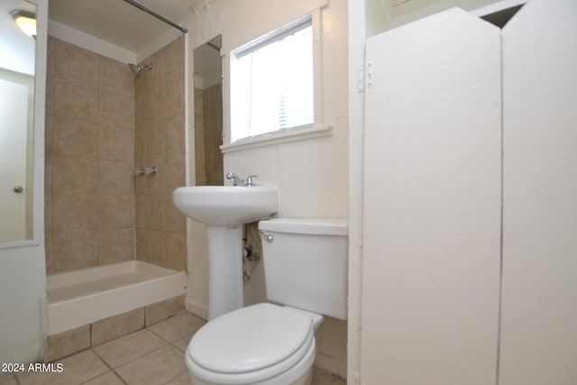 bathroom with toilet and tile patterned flooring