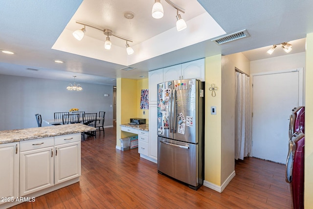 3408 W Carol Ave, Phoenix, AZ 85051 - kitchen featuring dark wood-style flooring, visible vents, freestanding refrigerator, a tray ceiling, and white cabinetry