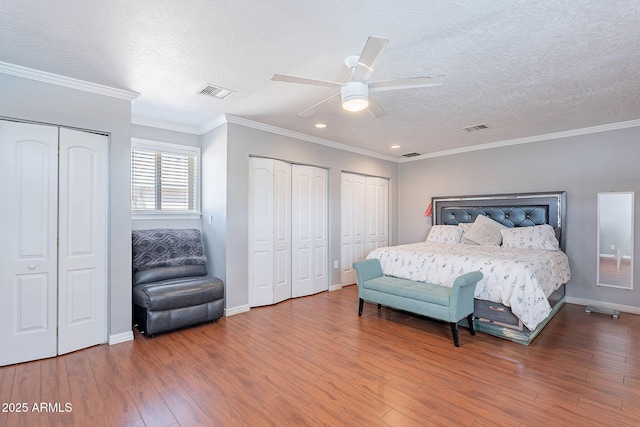 3408 W Carol Ave, Phoenix, AZ 85051 - bedroom featuring a textured ceiling, multiple closets, wood finished floors, and visible vents