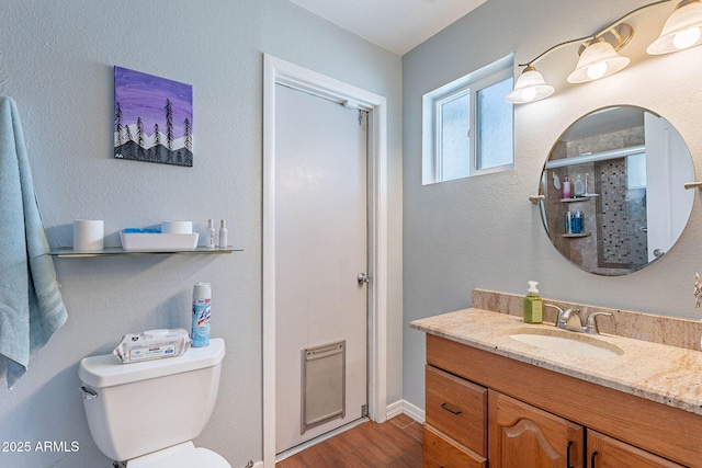 3408 W Carol Ave, Phoenix, AZ 85051 - full bathroom featuring vanity, toilet, baseboards, wood finished floors, and a shower with door