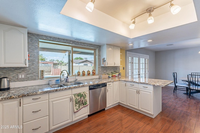 3408 W Carol Ave, Phoenix, AZ 85051 - kitchen featuring stainless steel dishwasher, a sink, a peninsula, and a healthy amount of sunlight