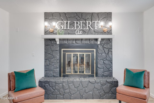 interior space featuring a stone fireplace and wood-type flooring