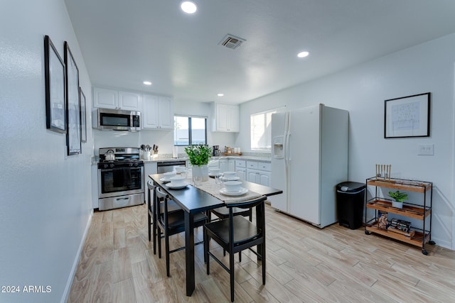 dining space with light hardwood / wood-style flooring