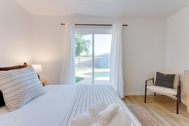 bedroom featuring access to outside and light hardwood / wood-style flooring