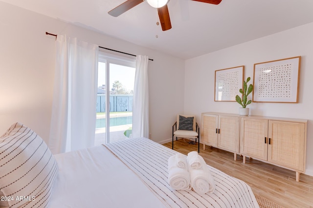 bedroom featuring access to outside, light hardwood / wood-style flooring, and ceiling fan