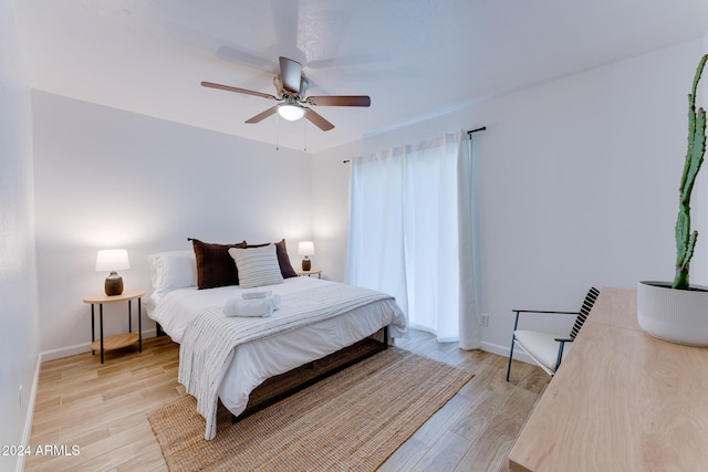 bedroom with ceiling fan and light wood-type flooring