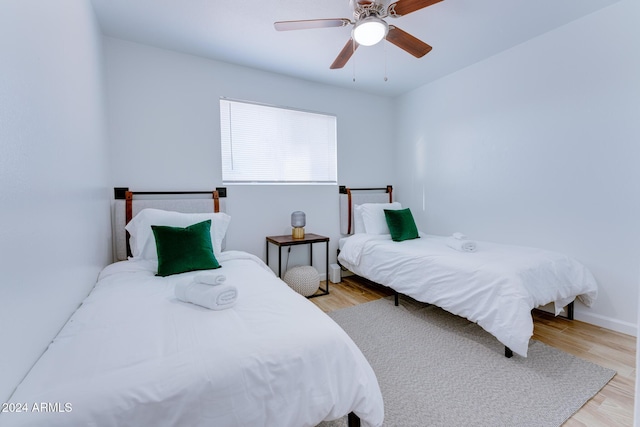 bedroom with ceiling fan and light hardwood / wood-style flooring