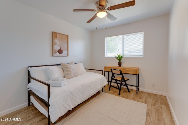 bedroom with ceiling fan and light wood-type flooring