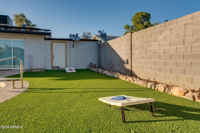 view of yard with central air condition unit