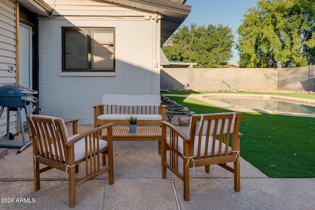 view of patio with a fenced in pool, a grill, and an outdoor hangout area