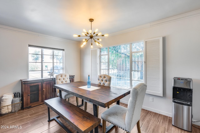 dining space featuring light hardwood / wood-style floors, ornamental molding, and an inviting chandelier