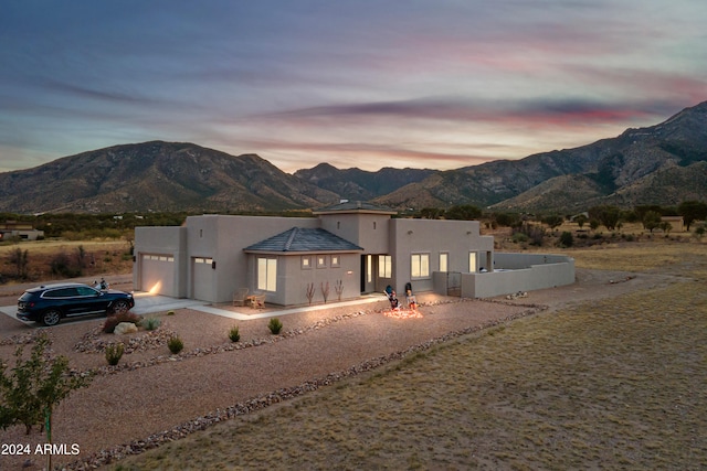 view of front of property with a mountain view and a garage