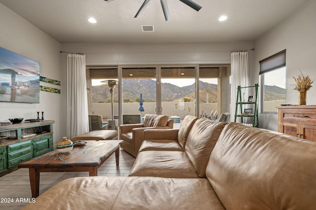 living room featuring a mountain view, ceiling fan, and light hardwood / wood-style floors