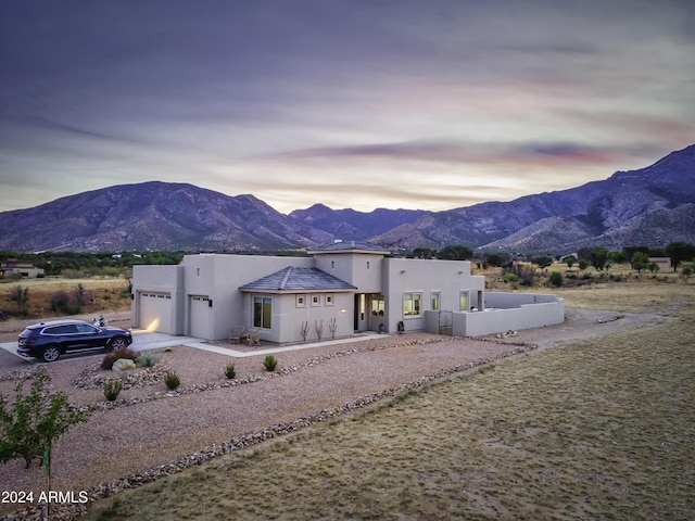 view of front of property featuring a mountain view and a garage