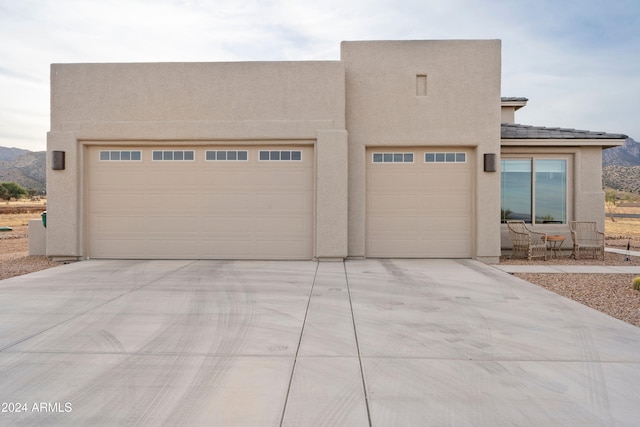 view of front of house with a mountain view and a garage