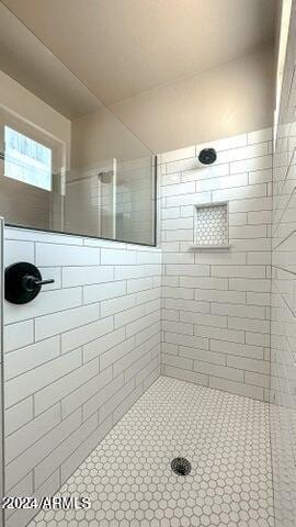 bathroom with tiled shower