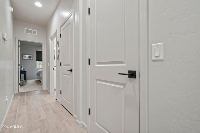 corridor with light wood-type flooring