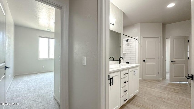 bathroom with hardwood / wood-style floors and vanity