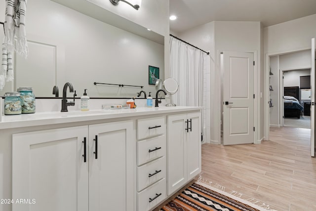 bathroom with vanity and wood-type flooring