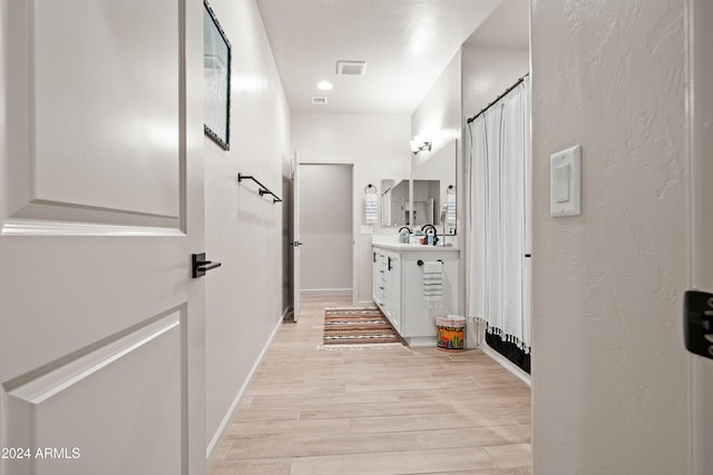 bathroom with hardwood / wood-style flooring and vanity