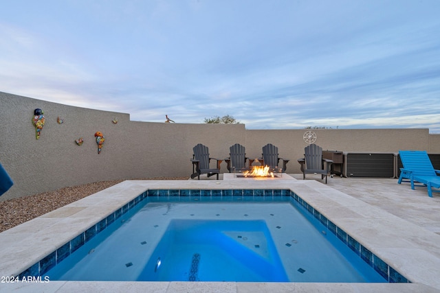 view of swimming pool with an in ground hot tub, an outdoor fire pit, and a patio area