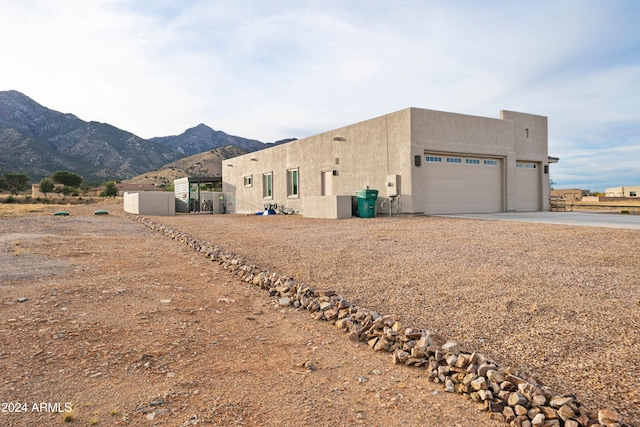 view of side of property featuring a mountain view and a garage