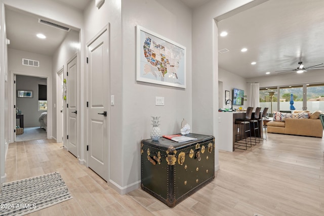 hallway with light hardwood / wood-style flooring