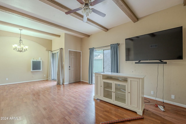 unfurnished living room featuring beam ceiling, ceiling fan with notable chandelier, and light hardwood / wood-style floors