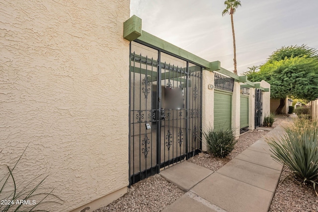 view of gate with a garage