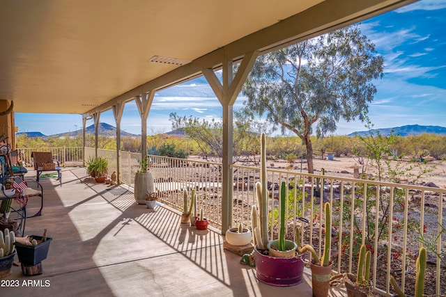 view of patio / terrace featuring a balcony and a mountain view