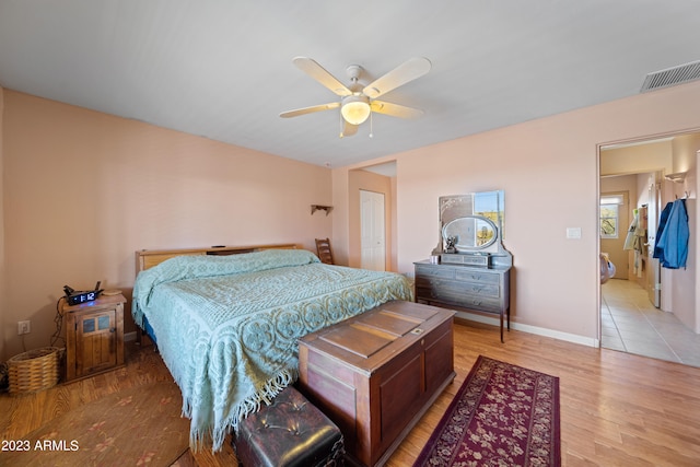 bedroom with a closet, hardwood / wood-style floors, and ceiling fan