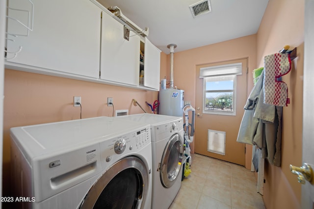 laundry room with light tile flooring, hookup for a washing machine, cabinets, and washer and clothes dryer