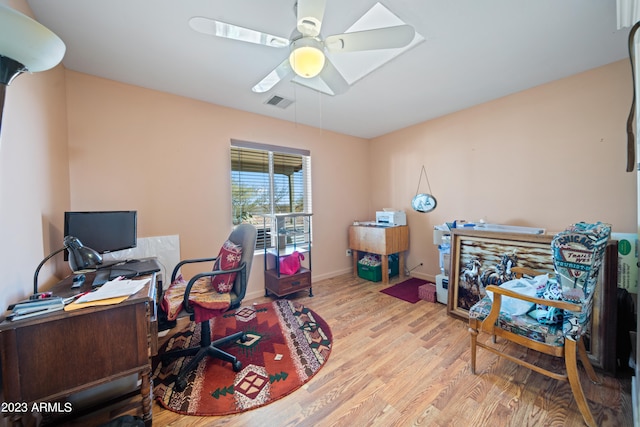 office space with light hardwood / wood-style floors and ceiling fan