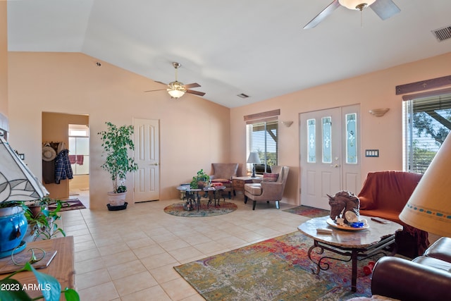 living room with ceiling fan, light tile flooring, and vaulted ceiling