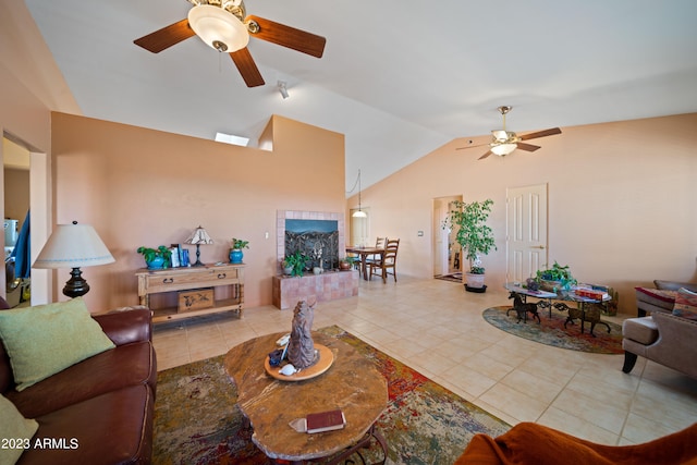 tiled living room featuring ceiling fan and vaulted ceiling