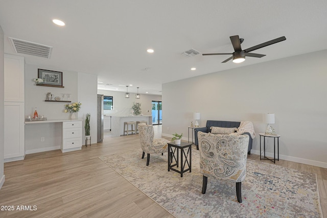 sitting room featuring light hardwood / wood-style flooring and ceiling fan