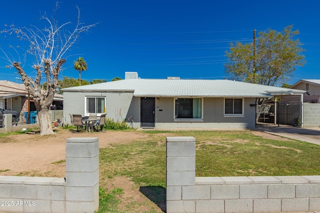 single story home with a gate, concrete block siding, a front lawn, and fence