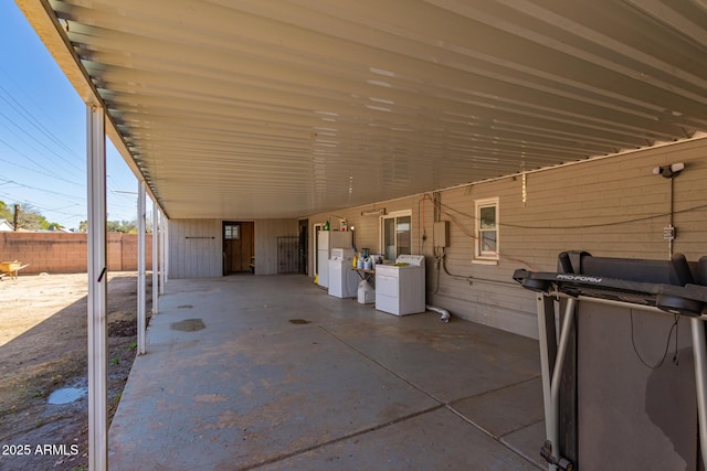 view of patio featuring a carport and fence