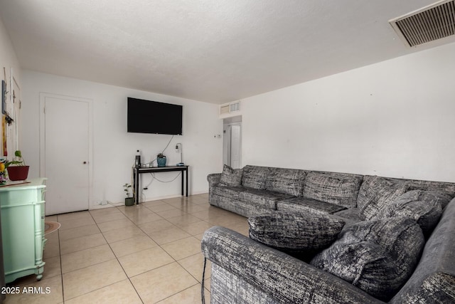 living area featuring light tile patterned floors and visible vents