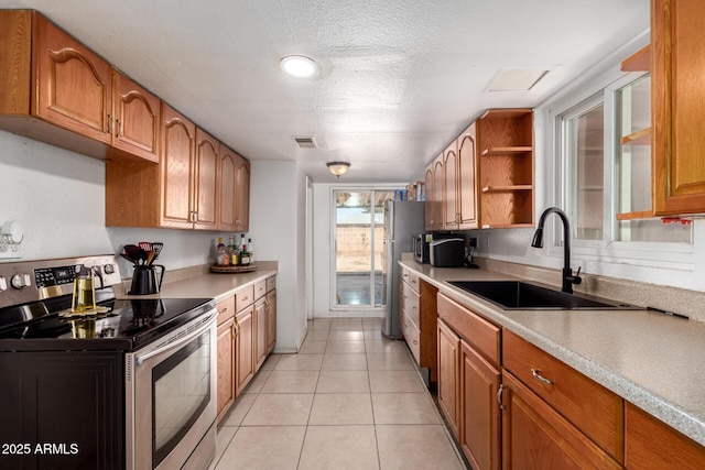 kitchen with visible vents, a sink, brown cabinets, appliances with stainless steel finishes, and open shelves