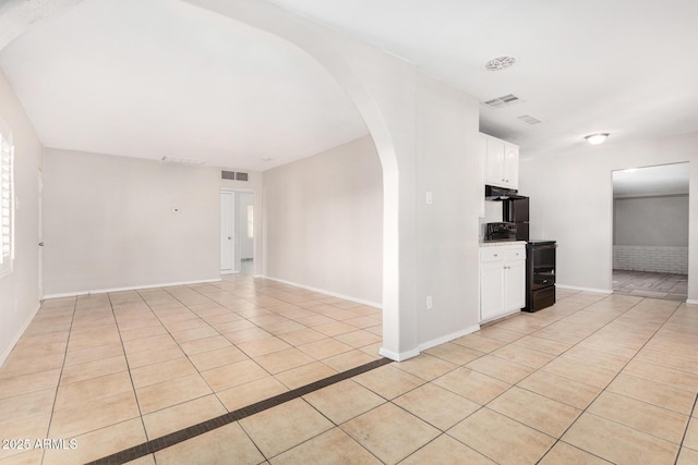 spare room featuring light tile patterned floors