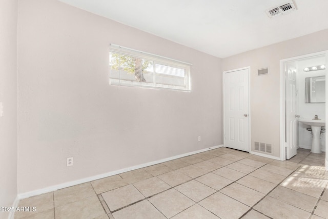 unfurnished bedroom featuring light tile patterned flooring