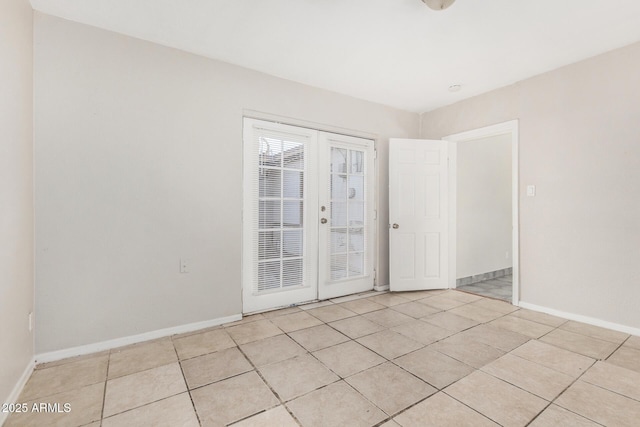 tiled spare room with french doors