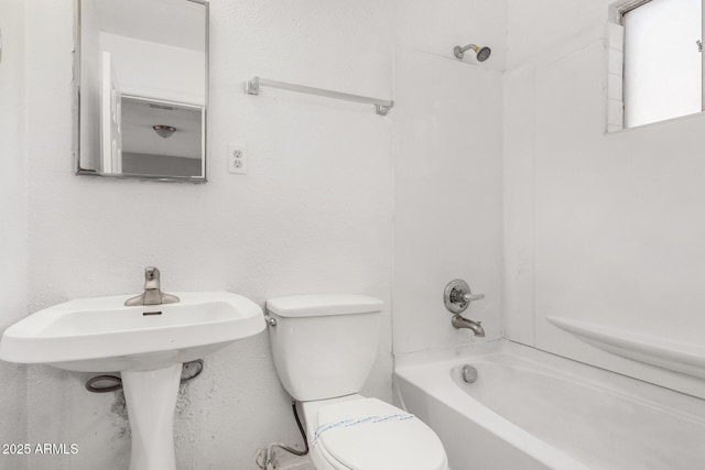 bathroom featuring shower / bathing tub combination and toilet