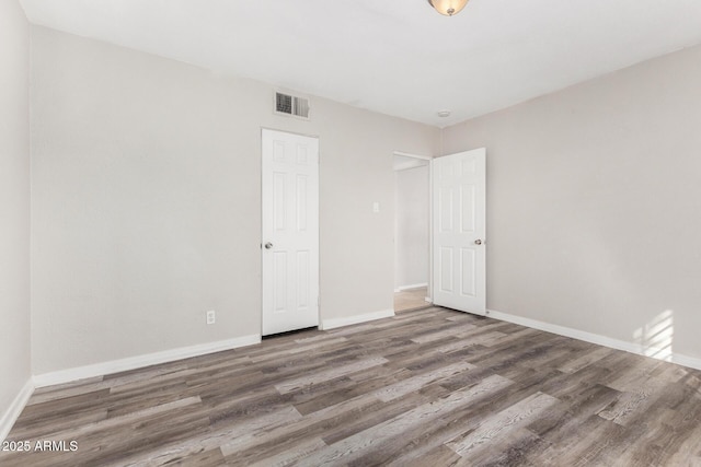 unfurnished bedroom with hardwood / wood-style floors