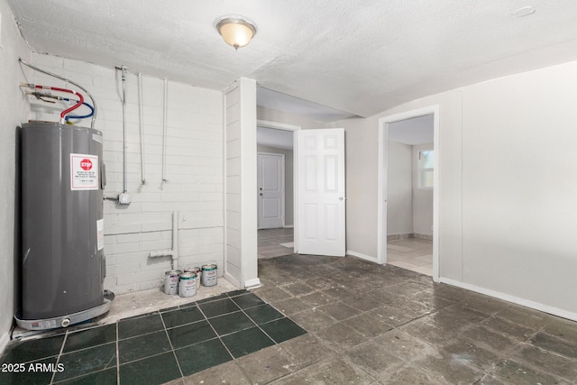 basement featuring electric water heater and a textured ceiling