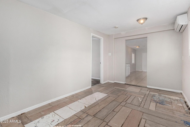 unfurnished room featuring a wall unit AC