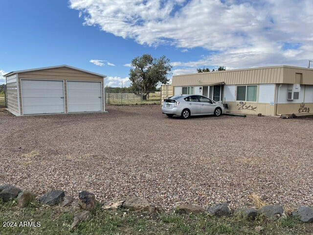 view of front of house with an outdoor structure and a garage