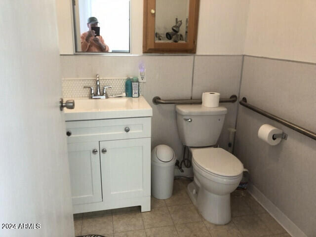 bathroom featuring toilet, tasteful backsplash, vanity, and tile patterned flooring