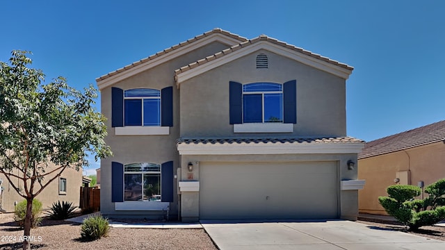 mediterranean / spanish-style home with a garage